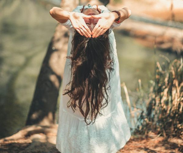 Calm person meditating in a peaceful natural environment.